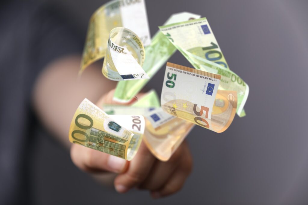 3d illustration of a bunch of euros in someone's hand in the background